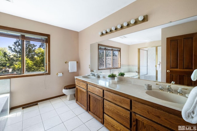 bathroom with a sink, baseboards, visible vents, and a wealth of natural light