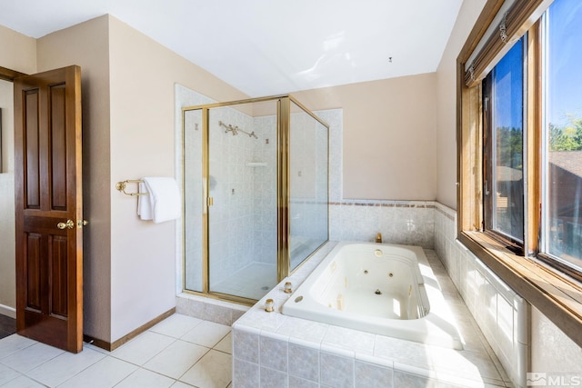 bathroom with a jetted tub, tile patterned flooring, a stall shower, and a wealth of natural light