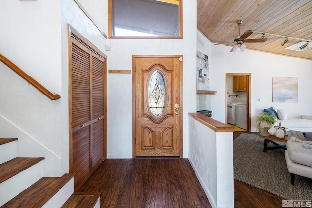 foyer entrance featuring washer and dryer, stairs, a ceiling fan, wood finished floors, and wood ceiling