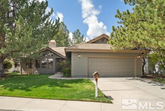 view of front of home with a garage, concrete driveway, a tile roof, and a front yard