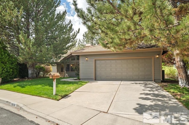 view of front facade with concrete driveway and a front yard