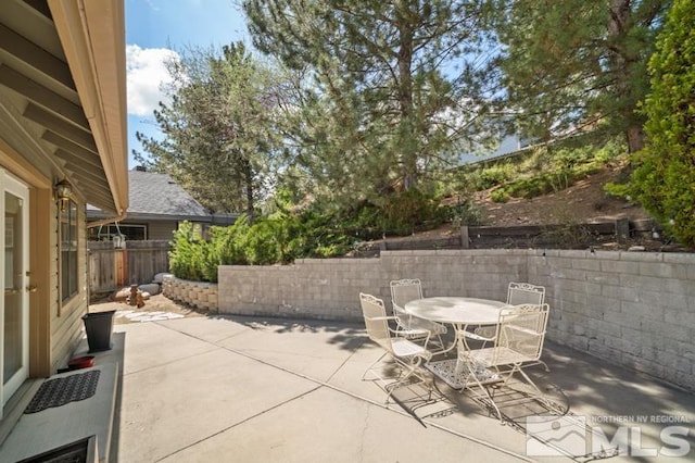view of patio with fence and outdoor dining space