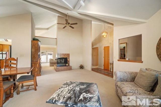 carpeted living room featuring high vaulted ceiling, ceiling fan, a fireplace, and beamed ceiling