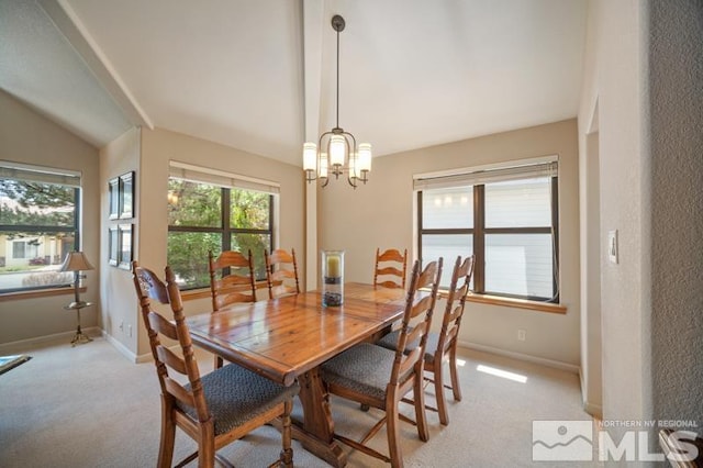 dining space with an inviting chandelier, baseboards, light carpet, and lofted ceiling