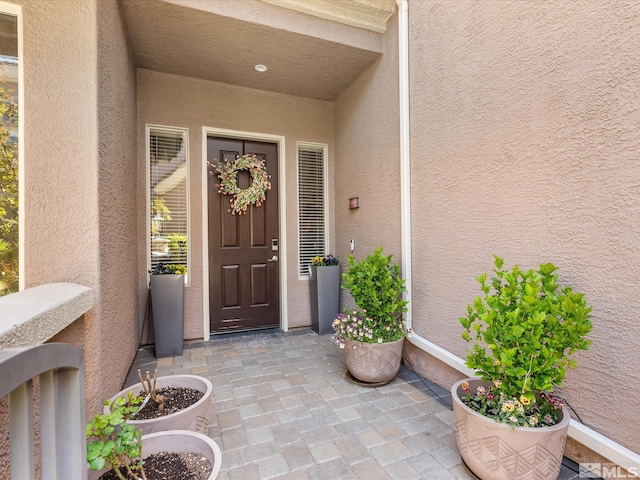 property entrance featuring stucco siding