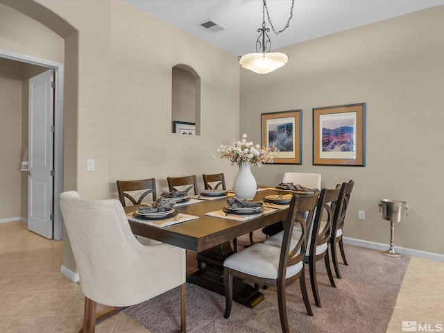 dining area featuring light tile patterned floors, baseboards, and visible vents