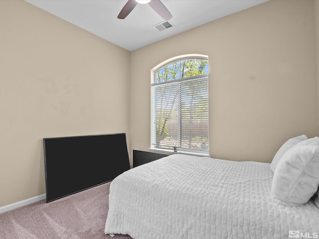 bedroom with visible vents, carpet flooring, baseboards, and a ceiling fan