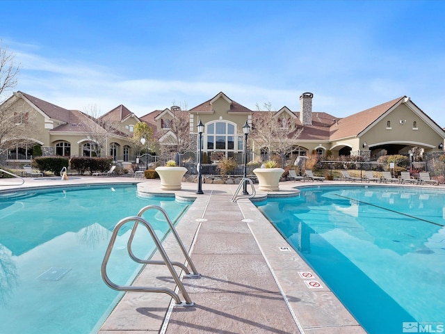 pool featuring a patio area and fence