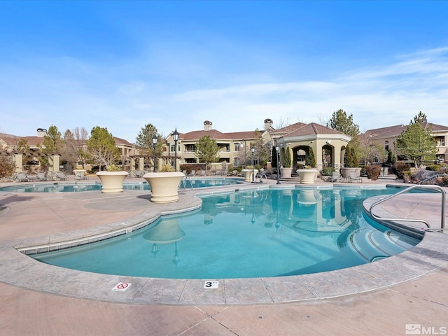 community pool featuring a patio area