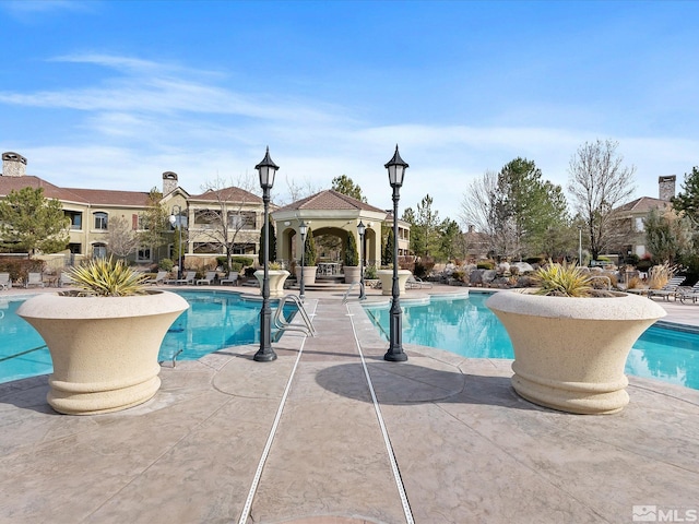 pool featuring a gazebo and a patio area