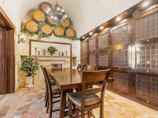 dining space featuring an inviting chandelier and stone finish flooring
