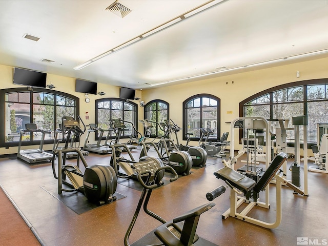 workout area with visible vents and a healthy amount of sunlight
