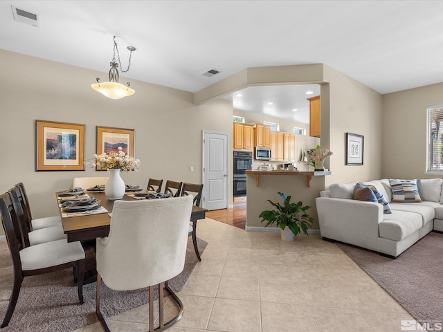 dining room with baseboards, light tile patterned flooring, and visible vents