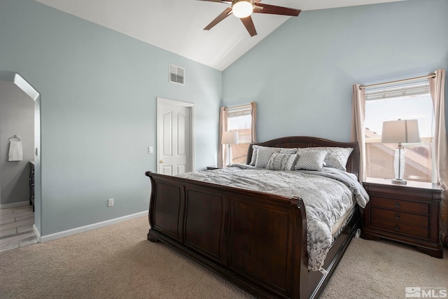 bedroom featuring visible vents, baseboards, light carpet, and high vaulted ceiling