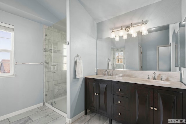 bathroom featuring baseboards, a shower stall, a sink, and marble finish floor