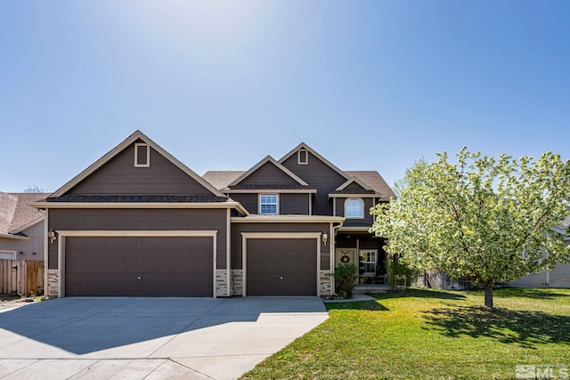 craftsman-style home featuring fence, driveway, stone siding, and a front lawn