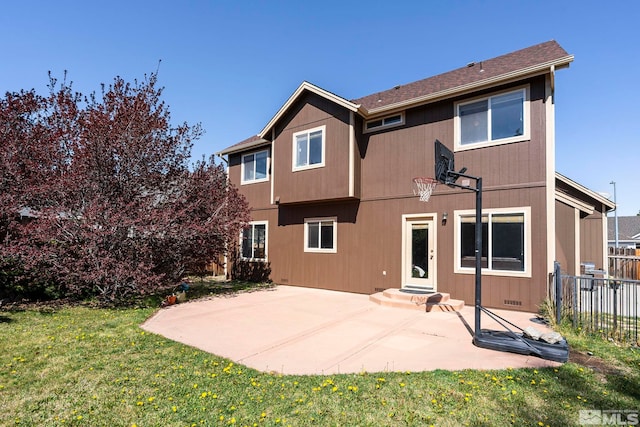 back of house featuring a lawn, fence, and a patio area