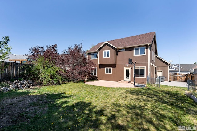 back of house with a patio, a fenced backyard, and a lawn