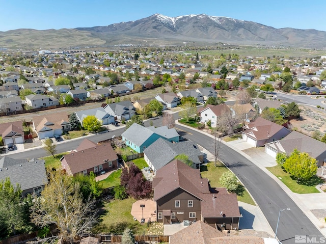 drone / aerial view featuring a residential view and a mountain view