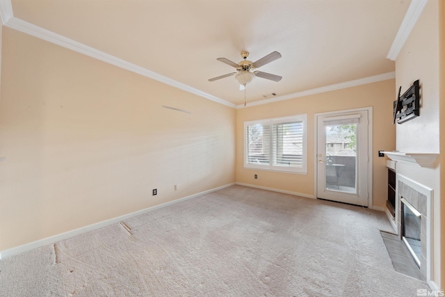 unfurnished living room featuring ornamental molding, baseboards, ceiling fan, light colored carpet, and a tile fireplace