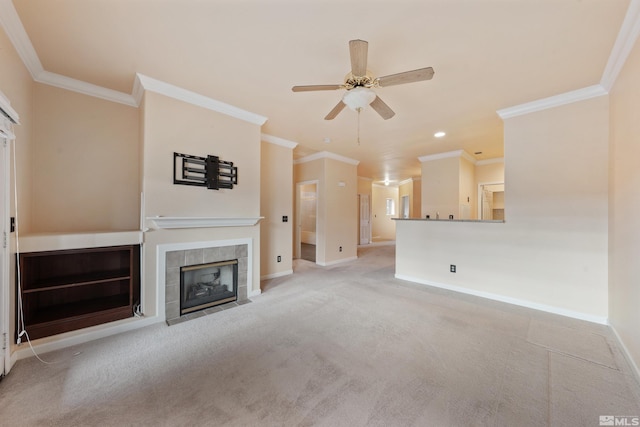 unfurnished living room with crown molding, a ceiling fan, baseboards, and a fireplace