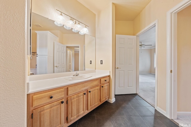bathroom featuring tile patterned floors, baseboards, and vanity