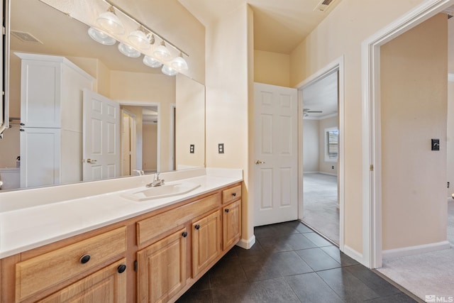 bathroom with baseboards, visible vents, tile patterned flooring, and vanity