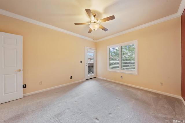 spare room featuring crown molding, ceiling fan, light colored carpet, and baseboards