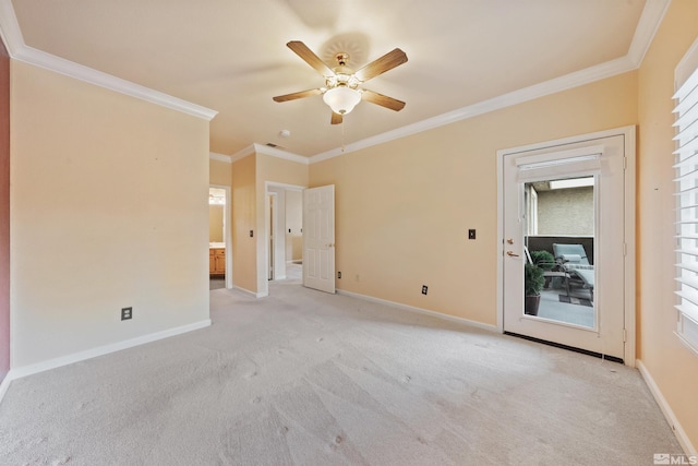 empty room featuring crown molding, a ceiling fan, baseboards, and light carpet