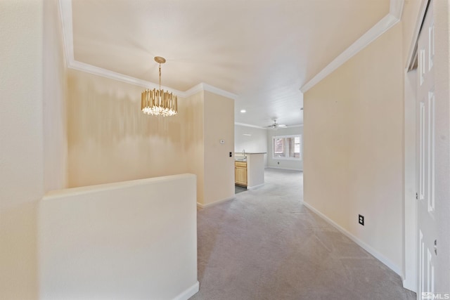 hall with crown molding, baseboards, and light carpet