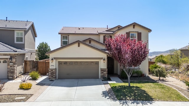 traditional-style house with a garage, stucco siding, driveway, and fence