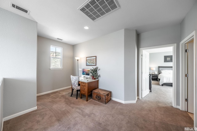 office area featuring carpet flooring, baseboards, and visible vents