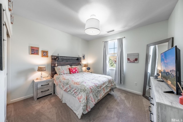 carpeted bedroom with baseboards and visible vents