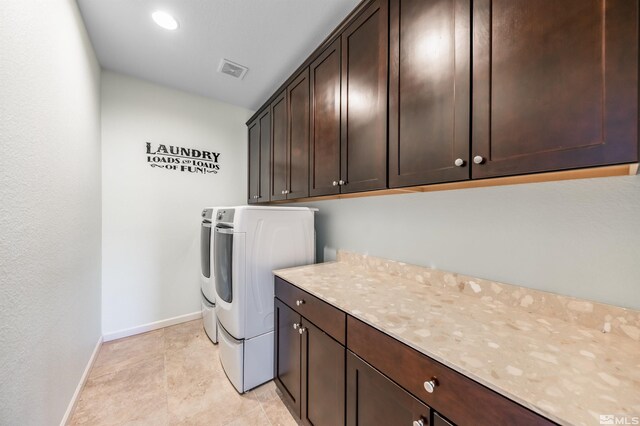 clothes washing area with visible vents, washer and dryer, baseboards, recessed lighting, and cabinet space
