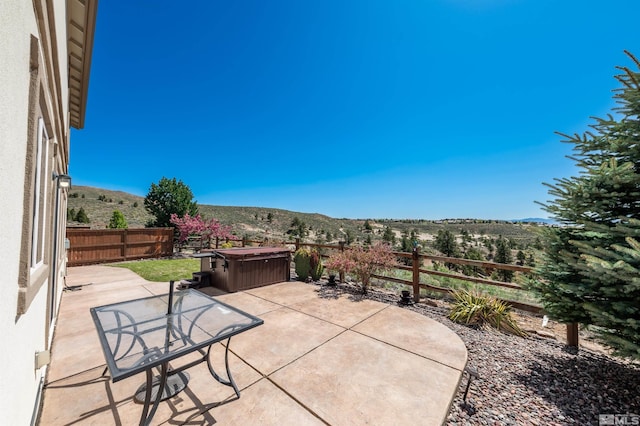 view of patio featuring a fenced backyard and a mountain view