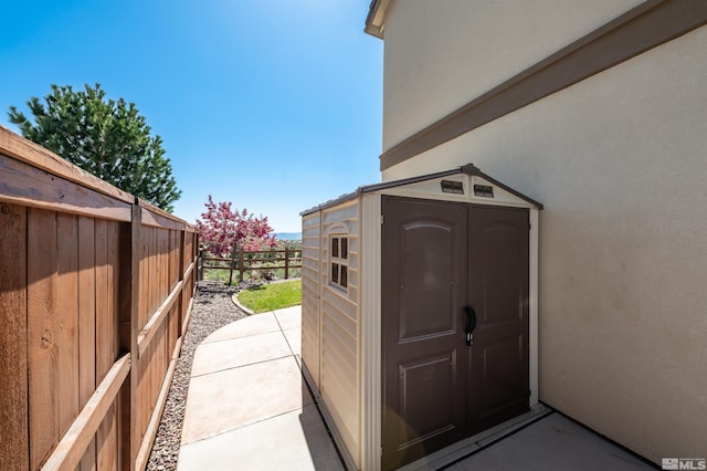 view of shed with fence