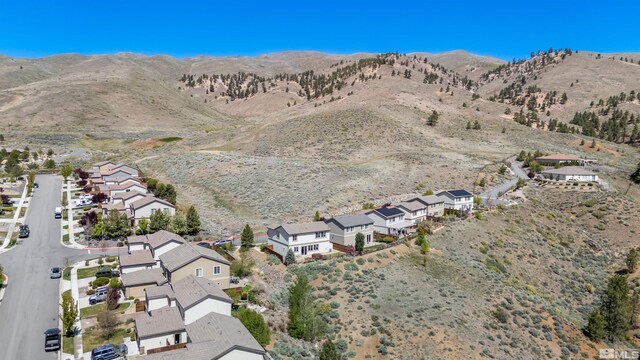 drone / aerial view featuring a residential view and a mountain view