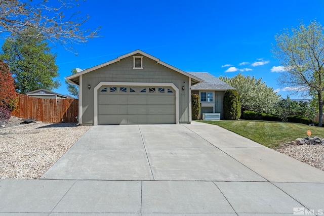 single story home with an attached garage, fence, a front yard, and concrete driveway