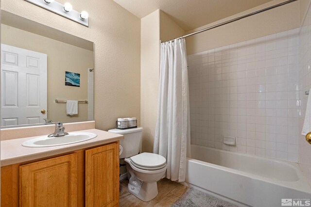 full bath with vanity, tile patterned flooring, toilet, and shower / tub combo with curtain