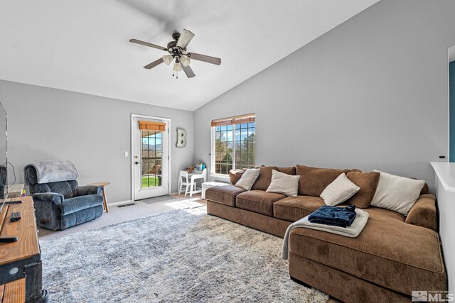 carpeted living area with ceiling fan, visible vents, baseboards, and lofted ceiling