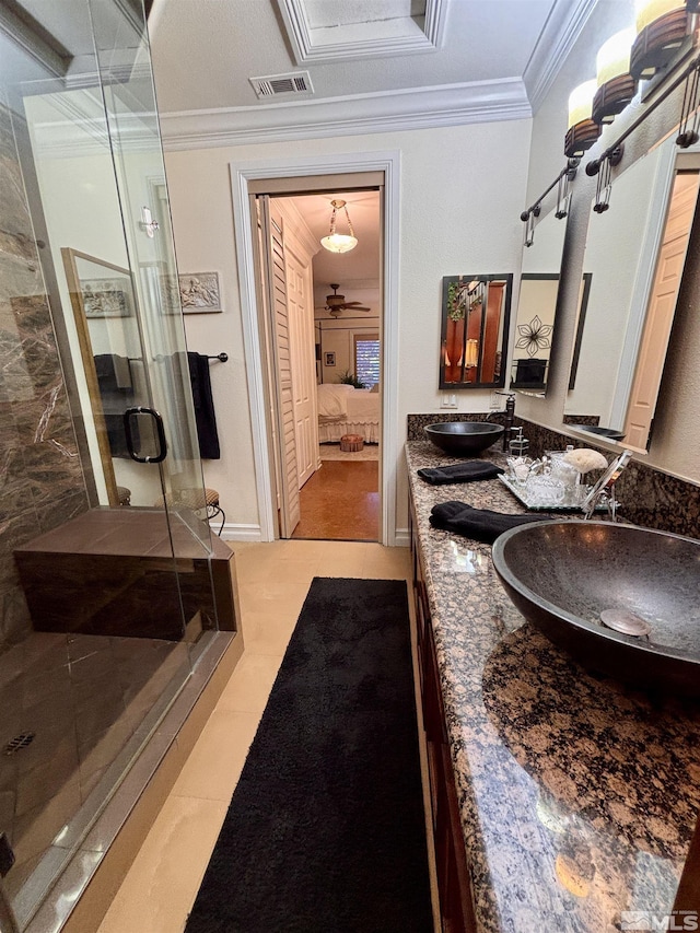bathroom with visible vents, ornamental molding, a shower stall, a sink, and ensuite bath