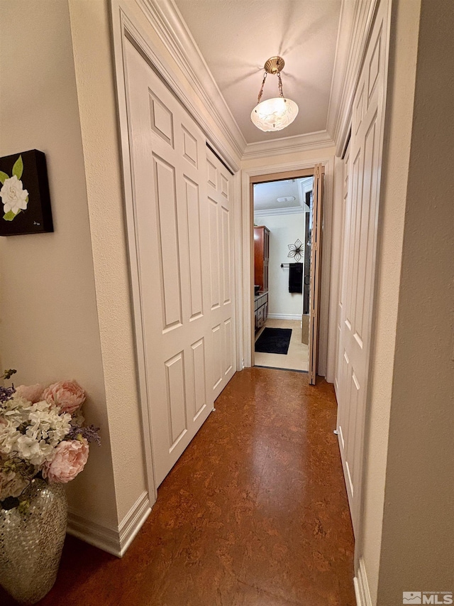 corridor featuring crown molding and baseboards