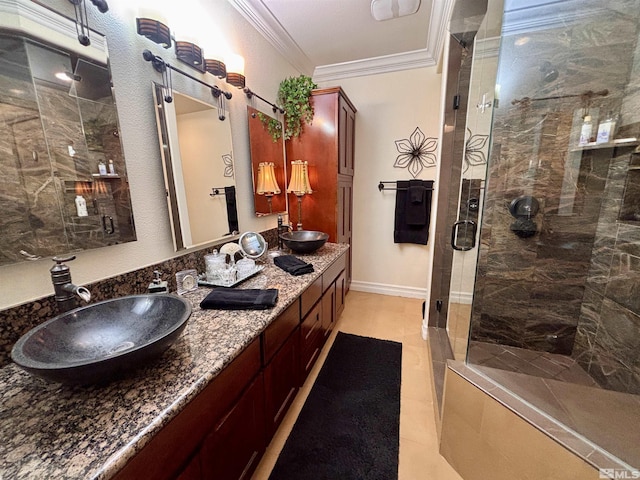 bathroom with double vanity, crown molding, a stall shower, a sink, and tile patterned floors