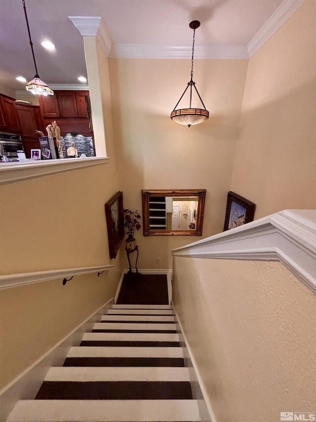stairs featuring baseboards, ornamental molding, and recessed lighting