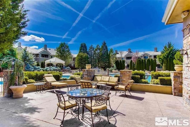 view of patio / terrace with fence and a residential view