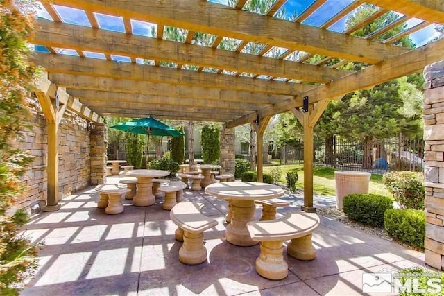 view of patio / terrace featuring outdoor dining area, fence, and a pergola