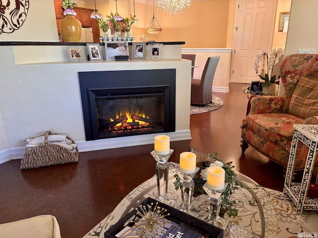 living area with baseboards and a glass covered fireplace