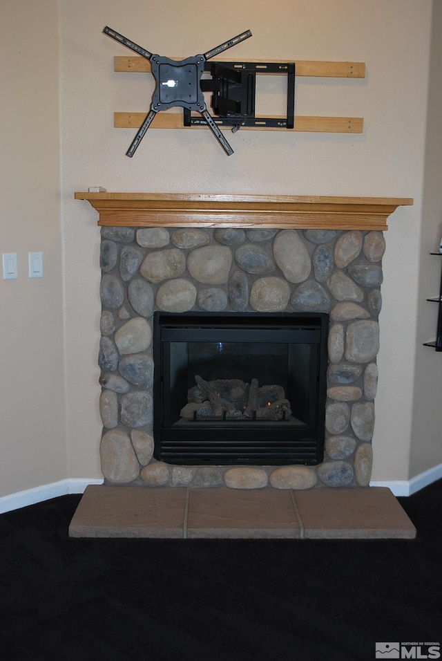 interior details featuring baseboards and a fireplace