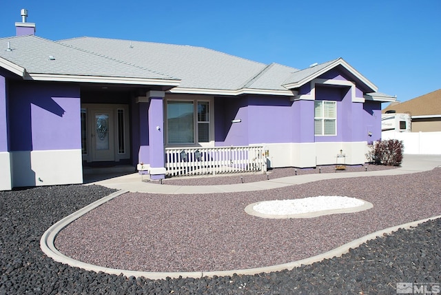 single story home featuring stucco siding and a porch