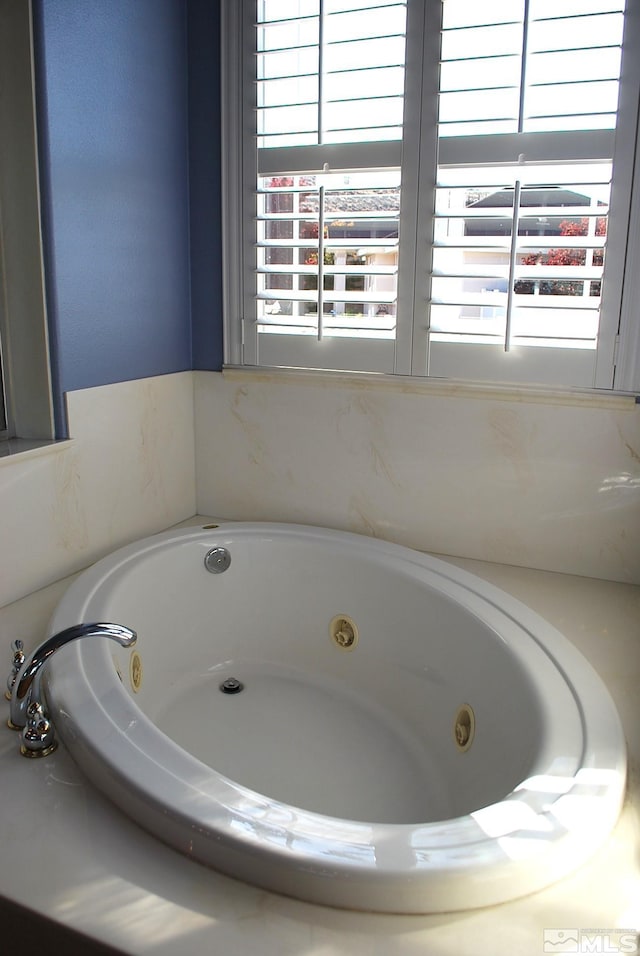 full bathroom featuring a tub with jets